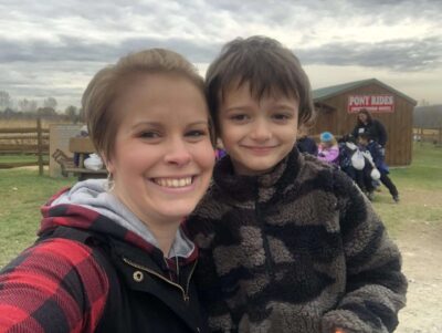 Mother and son smiling at the camera at Roba's Farm