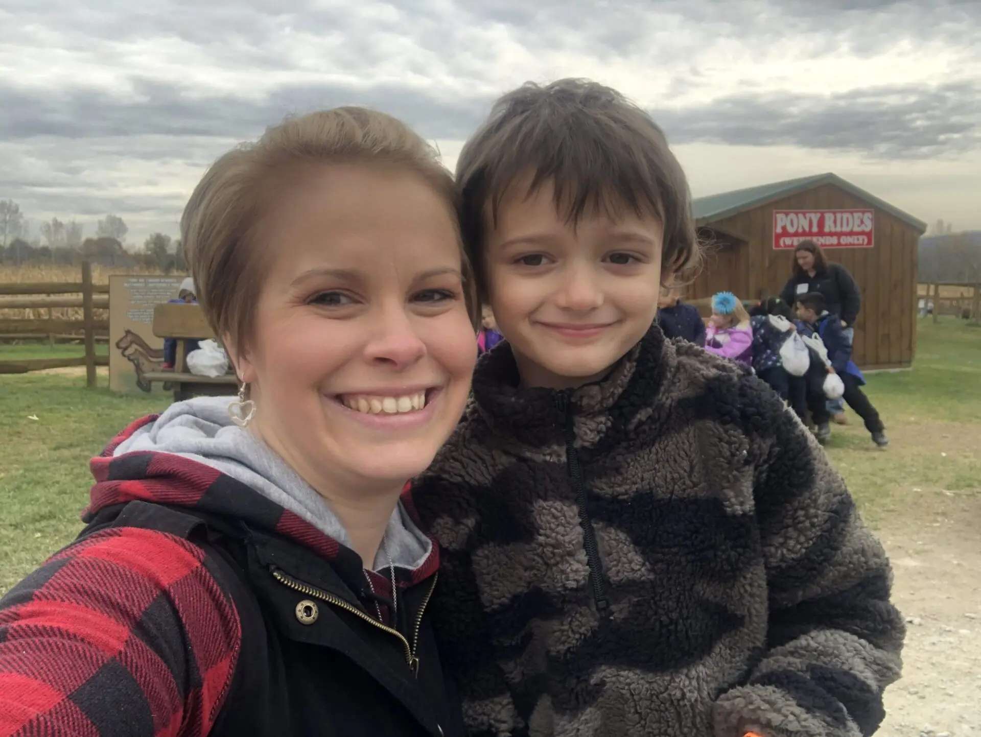 Mother and son smiling at the camera at Roba's Farm