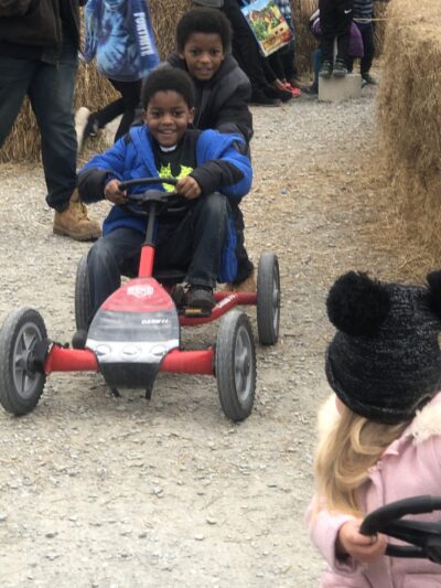Little students driving a toy car