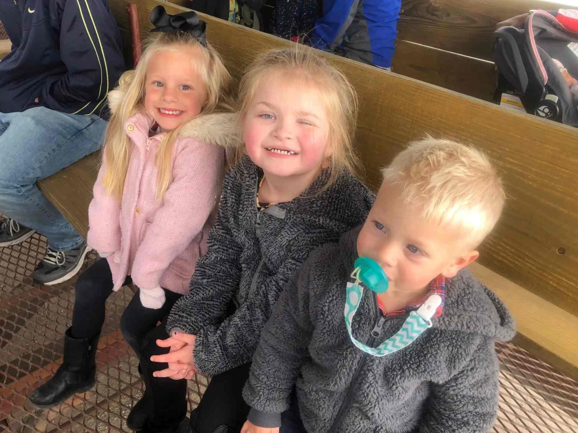 Little students seated and smiling at the camera