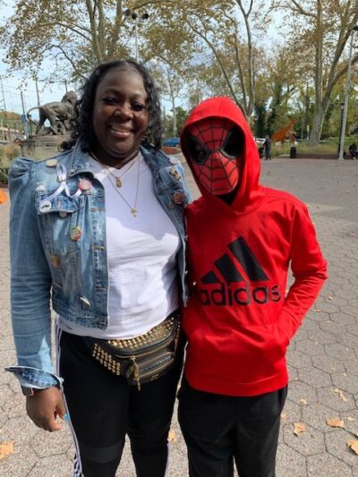Mother and her child wearing a Spider Man mask