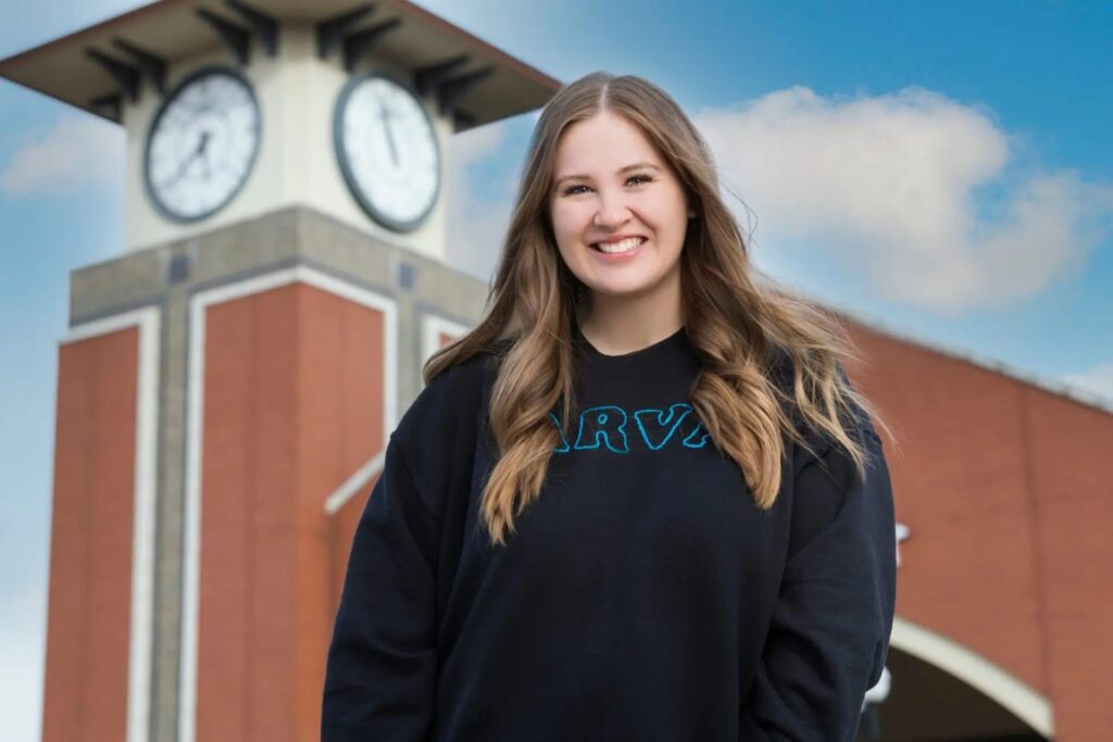 Girl smiling wearing an Arva hoodie