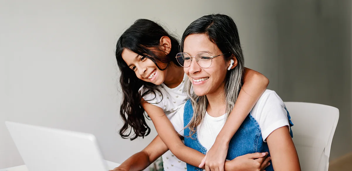 Mother and daughter using thei laptop together