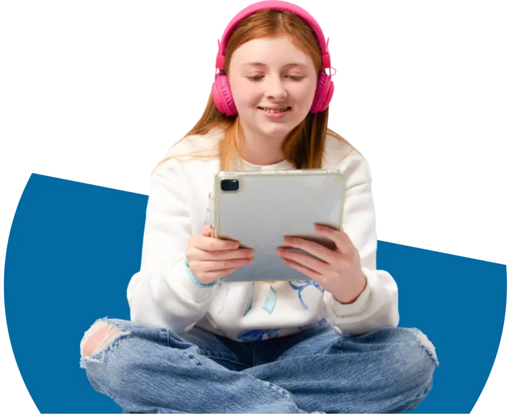 Student using her tablet wearing a pink pair of headphones
