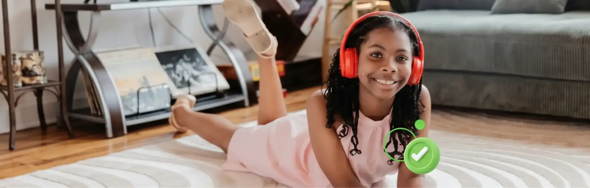 Student wearing a red pair of headphones and a pink dress