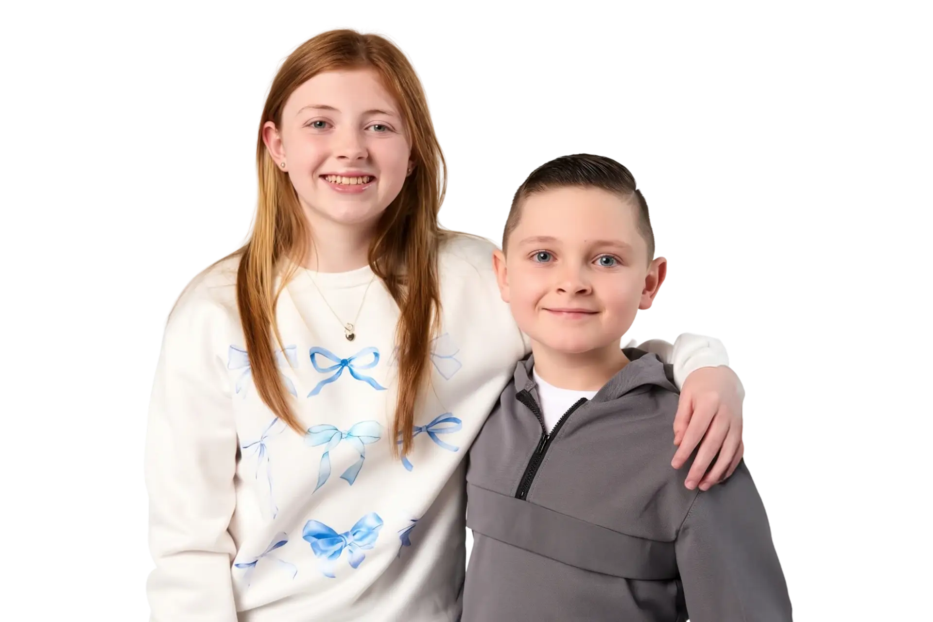 Students hugging and smiling at the camera. Shes is wearing a white shirt and he is wearing a gray zipped hoodie