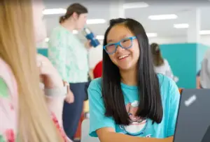 Student wearing glasses and a light blue shirt